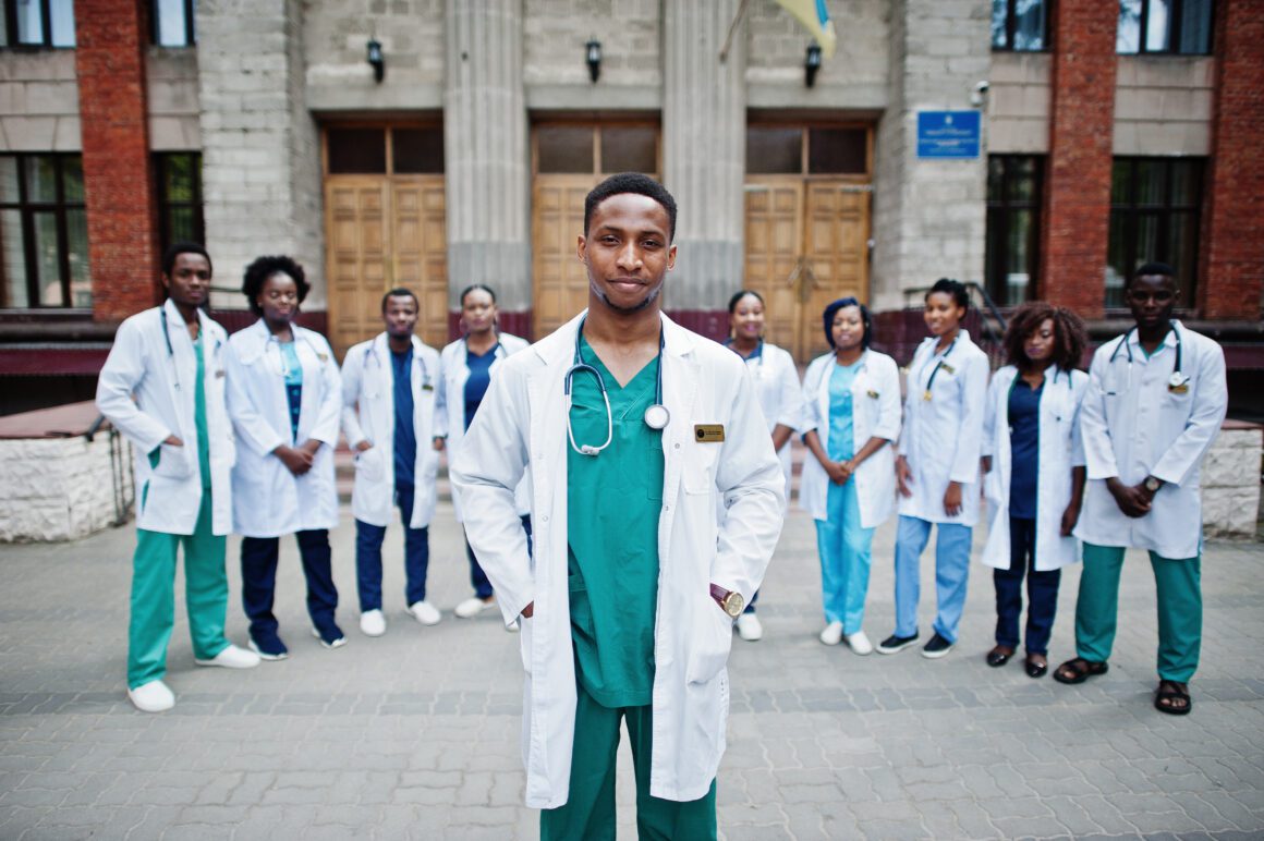 Group of african doctors students near medical university outdoo African medical students in white coats.