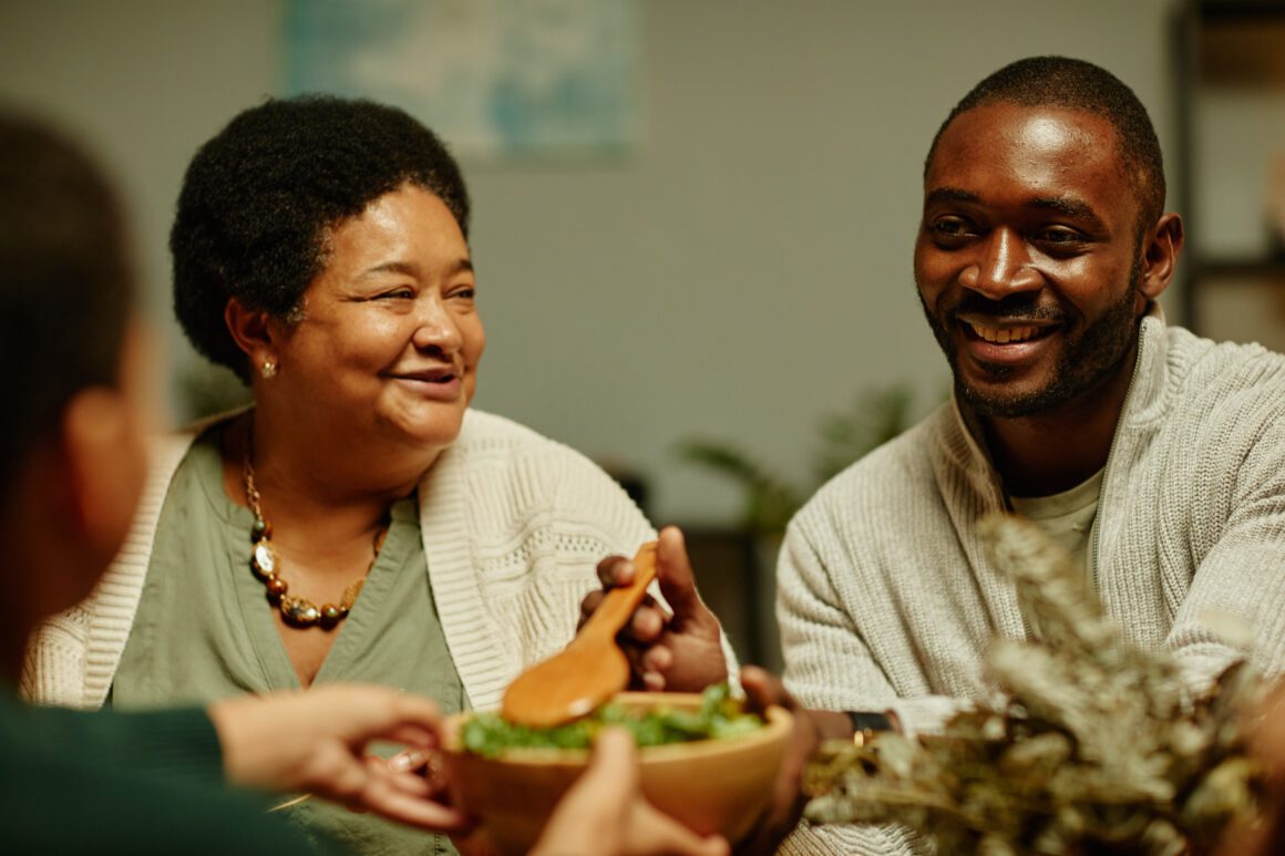 Happy African American Family at Dinner Happy family sharing a meal together.