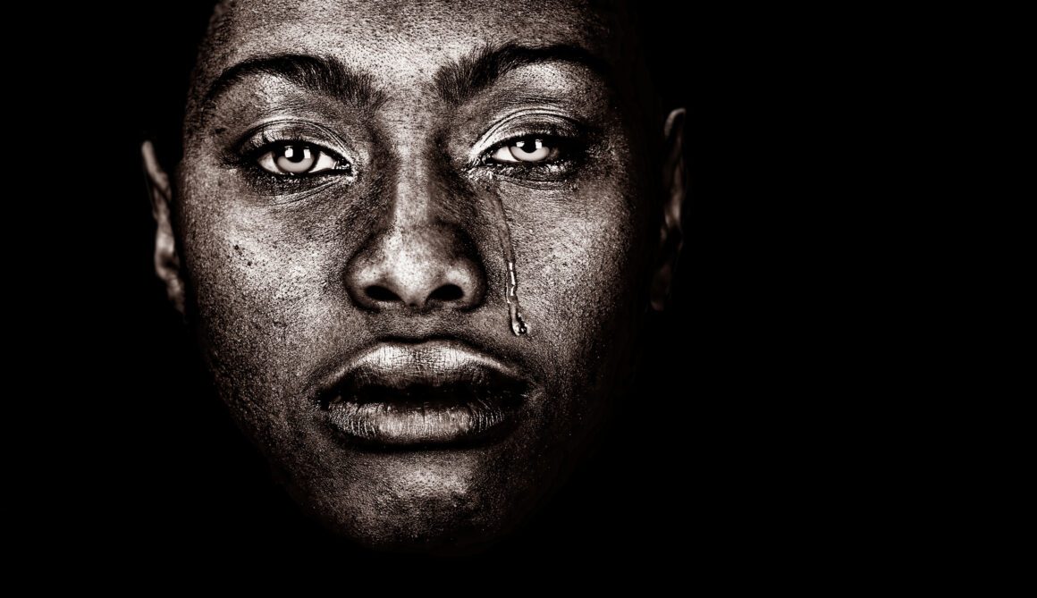 Afro American Woman Here's an alt tag for the image: Close-up of a crying woman's face.